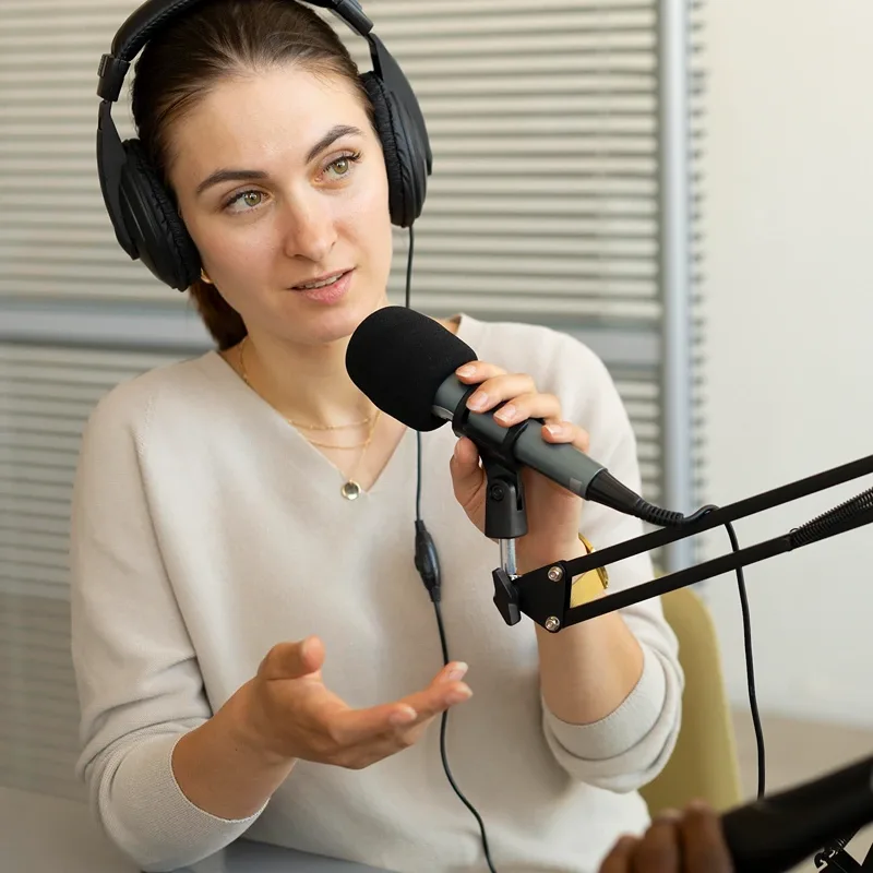 A guest speaking into a podcast microphone